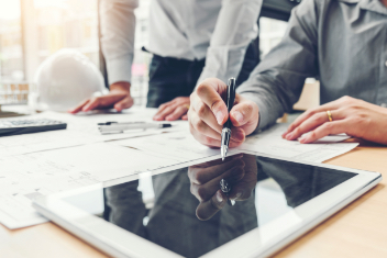Two professionals work on an tablet 