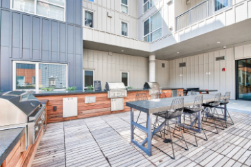 Outdoor seating area with multiple BBQ grills