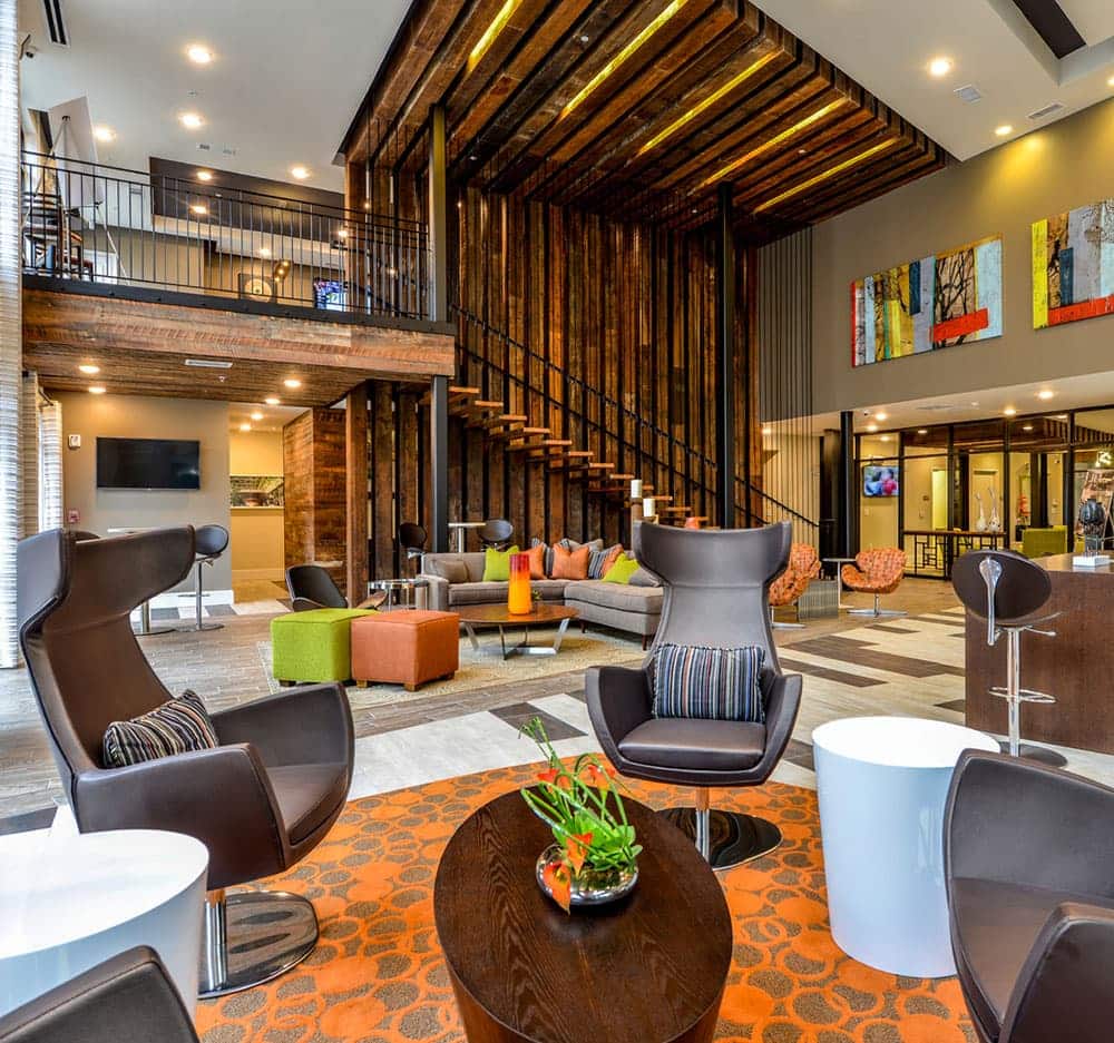 Colorful 2-story apartment clubhouse with wood paneling