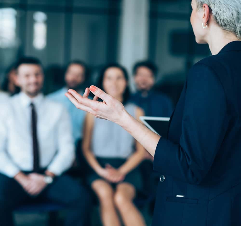 Businesswoman in a blue blazer delivering a presentation