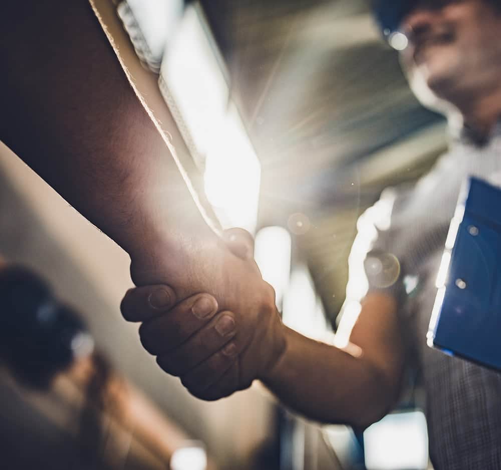 Two men shake hands