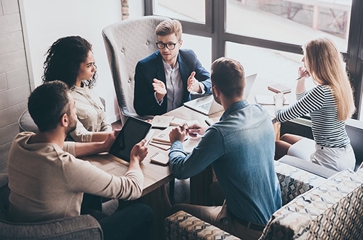 bell corporate plan 2020 A group of young professionals hold a meeting