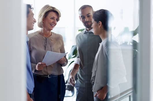 bell corporate plan 2020 A group of professionals stand and talk together