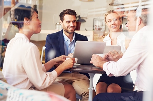 bell corporate plan 2020 4 working professionals sit a table together